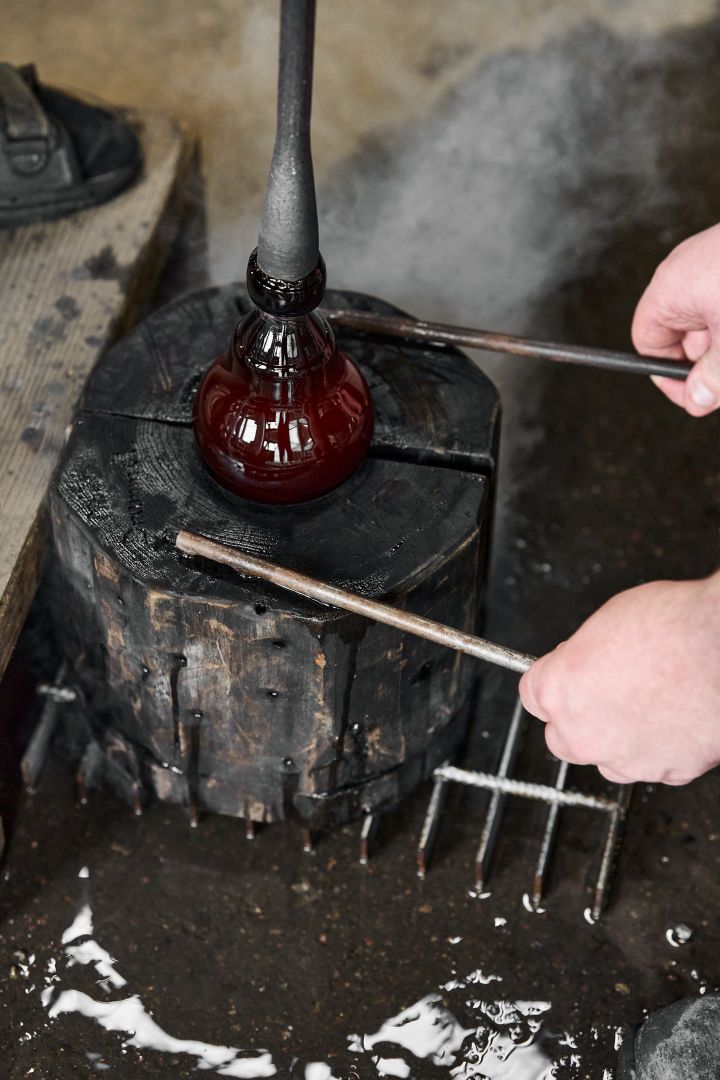 Bild som visar när vasen Drummel blir till, här ser man glasmassan i formen som hålls ihop av glasblåsarna.