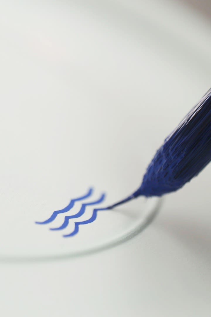 Royal Copenhagens signatur på sitt blåvita porslin, tre blå vågor som representerar Danmarks tre vattenvägar.